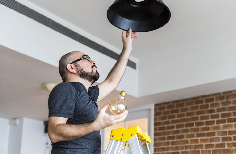 Man changing light bulb