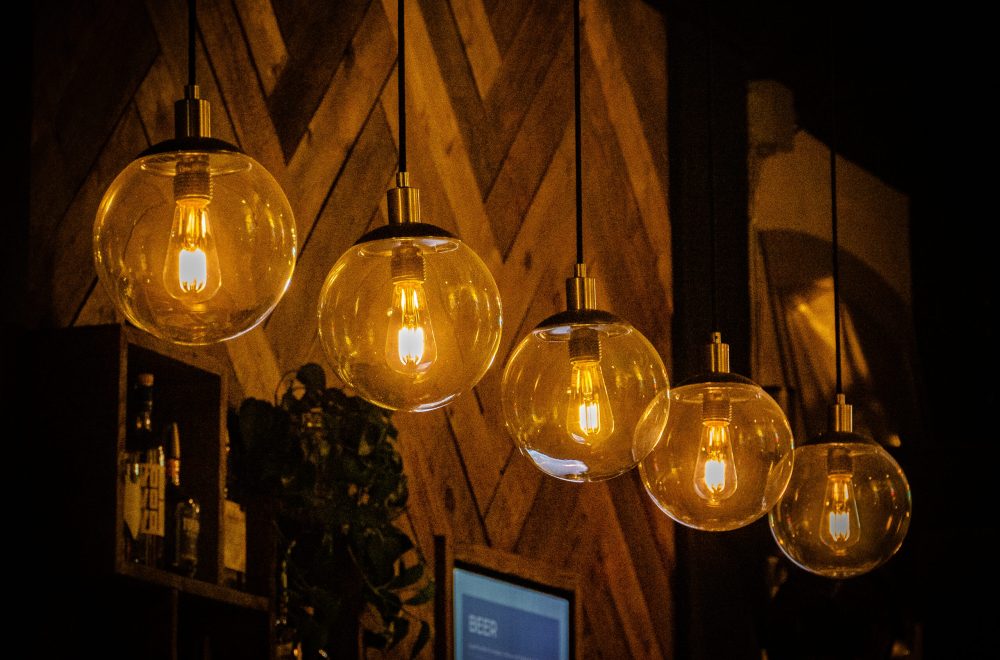 A row of decorative light bulbs hanging in a cafe