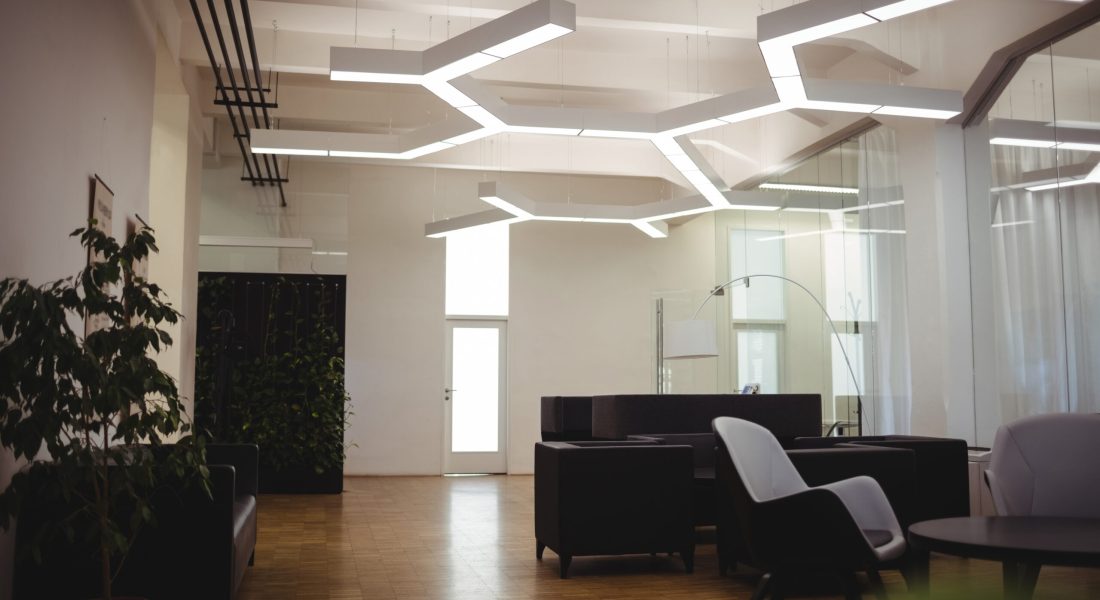 View of empty modern office with sofa, table, chair